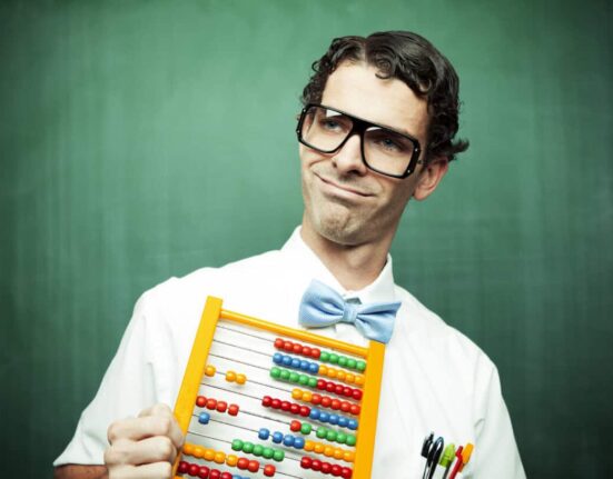 man in bowtie poses with abacus