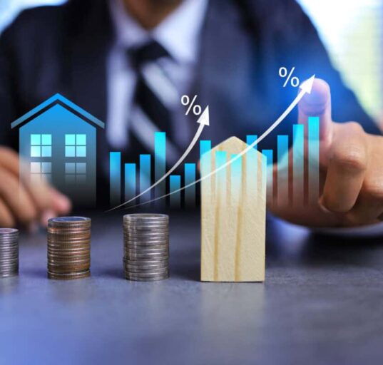 Real estate investment concept with person pointing on growth graph and coin stacking to get profit from property