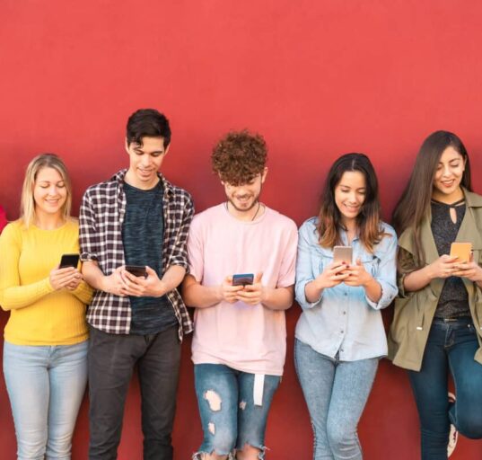 young people stare at smartphones