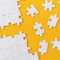 Partially complete jigsaw puzzle with scattered missing pieces