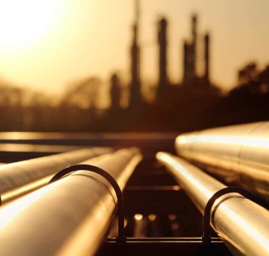 golden sunset in crude oil refinery with pipeline system