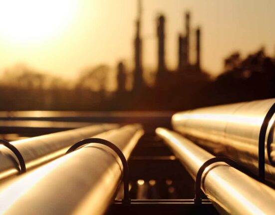 golden sunset in crude oil refinery with pipeline system