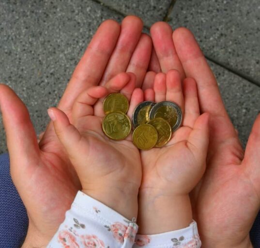 holding coins in hand for the future