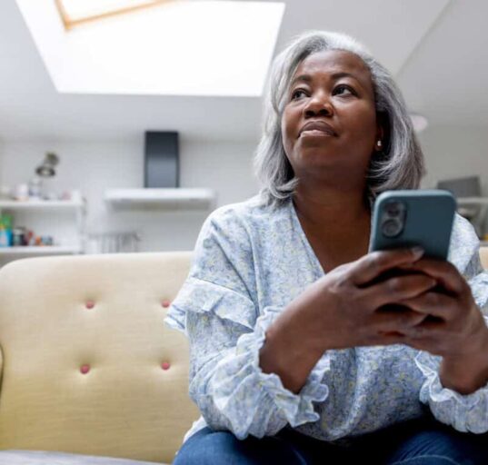 woman looks at iPhone